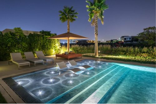hsn-white-cloud-sanded-exterior-swimming-pool-baja-shelf-and-seating-area-nighttime